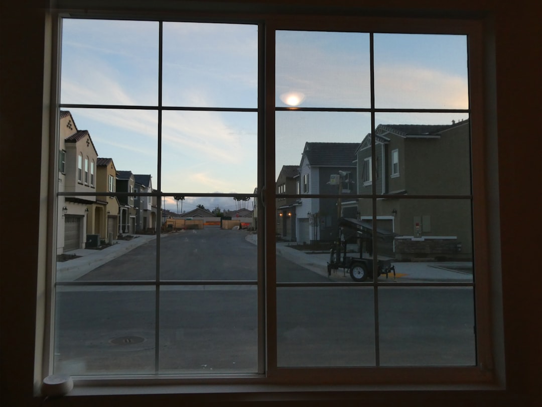 7e3484743a8546c99742314371169de5 A street scene viewed through a window