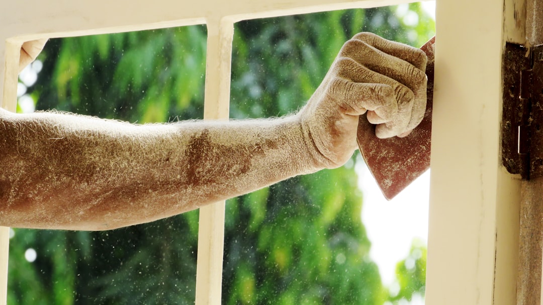 b71d72cb01b648d9a23243e26206d2dc a man's arm is covered in dirt as he opens a window