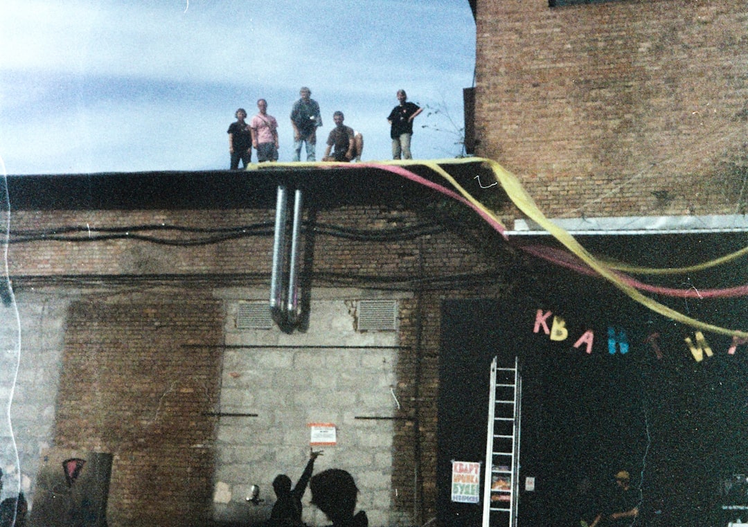 bc9663cfd1c9407db71cc0ab435ba3a8 People gathered on a rooftop with festive decorations.