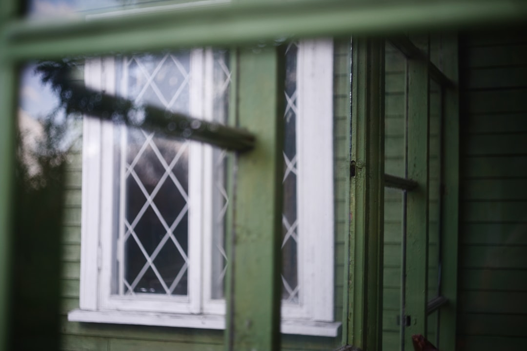 ce43d4c3ad2a46e39354d8d52785bdb0 Green wooden house with a diamond-paned window