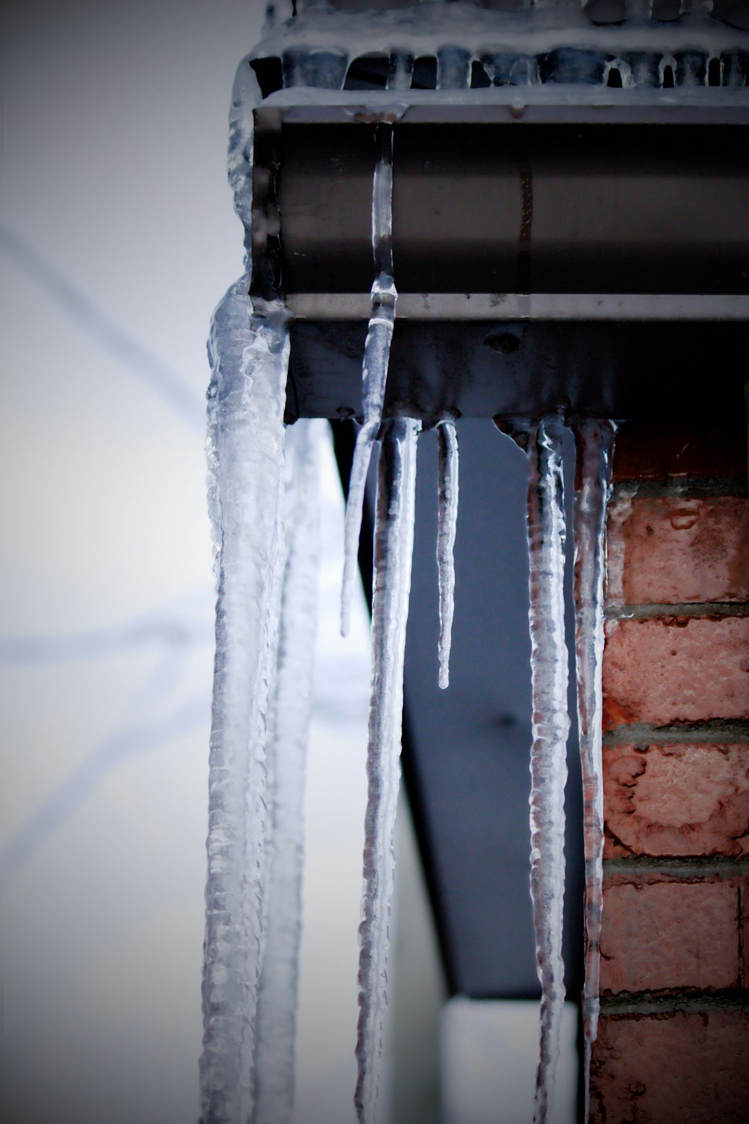 cf7af81aef7a4e3d8763c8ea42ce499a icicles hanging from the roof of a building