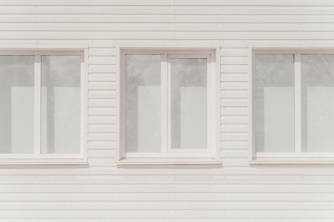 cf8cac8e73d34c109ed3c0b0197907fe Three white windows on a white paneled wall