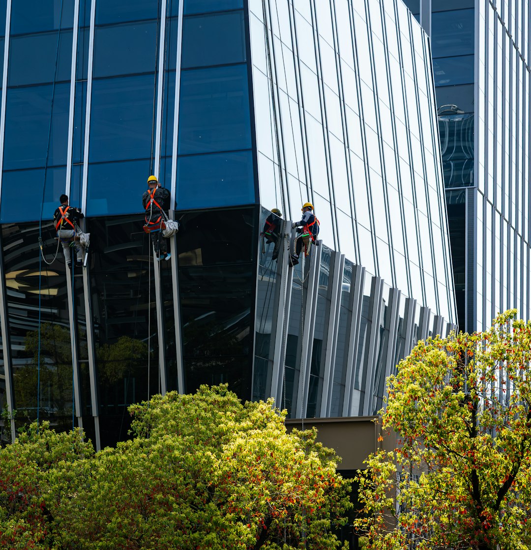 Workers cleaning windows on a modern glass building