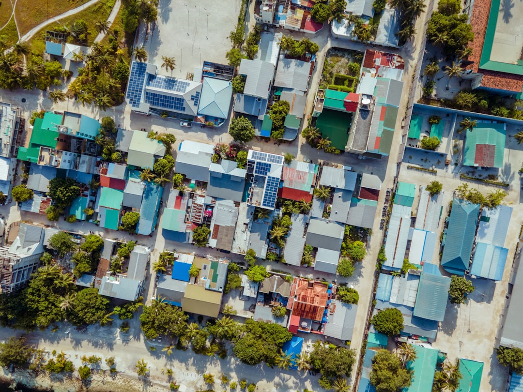 Aerial view of a tropical island village with colorful roofs