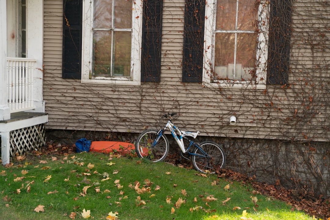 A bicycle is parked in front of a house