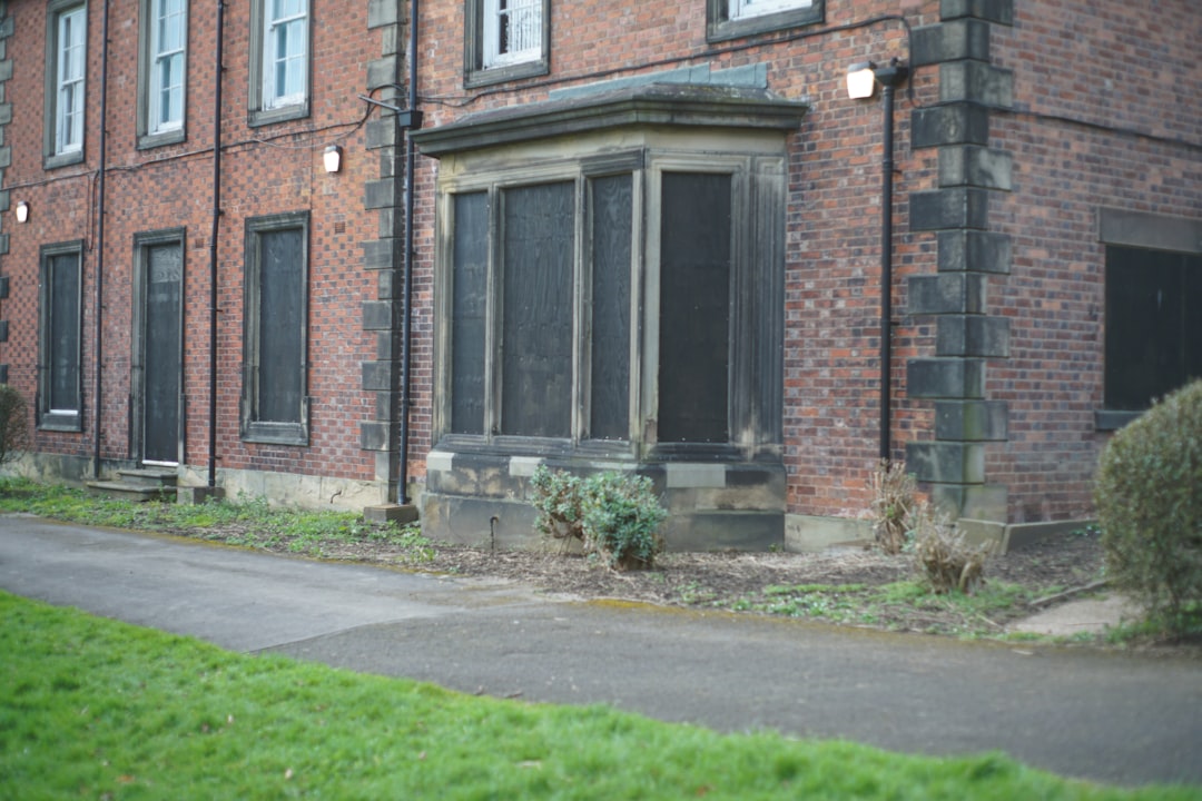 A brick building with a bay window and a path