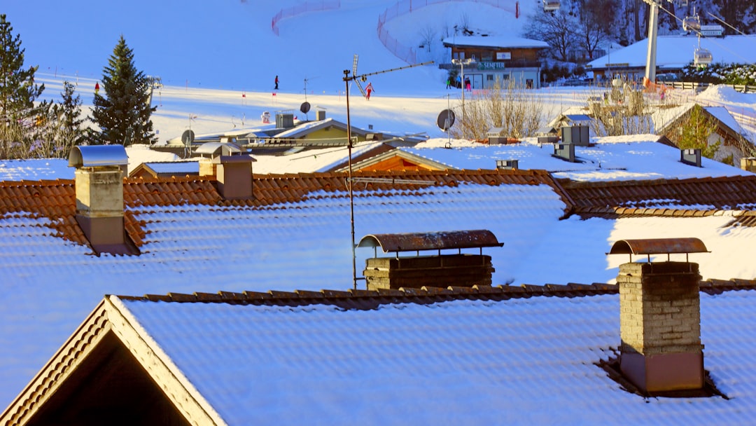 brown wooden house on snow covered ground during daytime