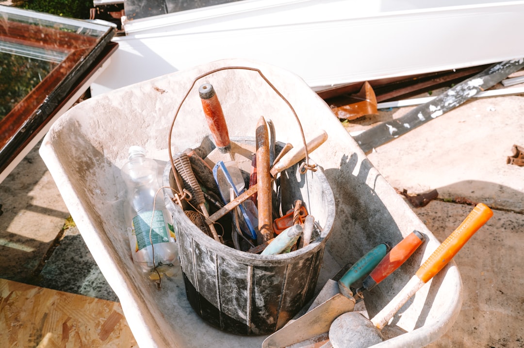 e64a5da4812e44a49c4afcdd294fa9a1 Bucket of hand tools in a wheelbarrow