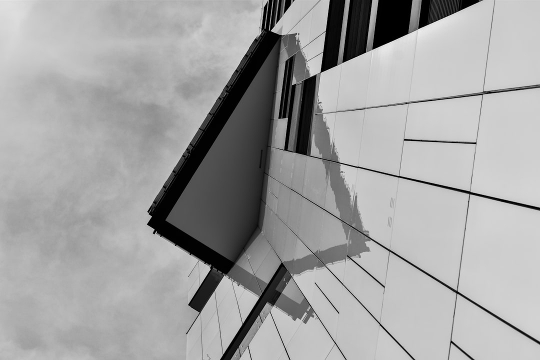 ea57d68d20d54e84b27a0759b159ed1e grayscale photo of glass building