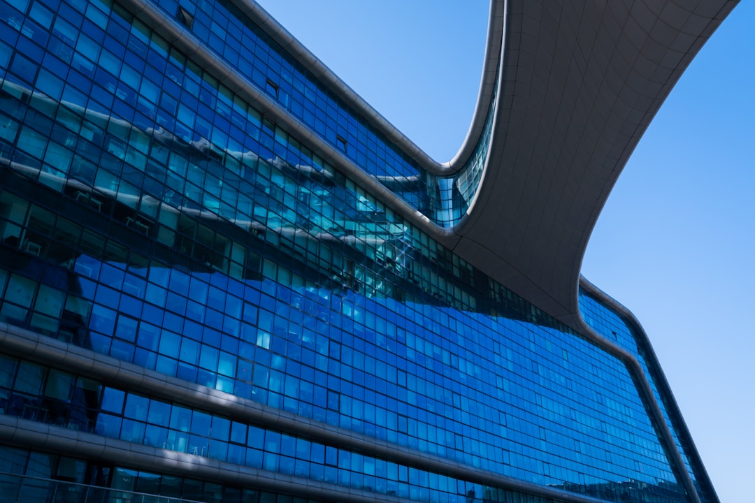Modern blue glass building against clear sky