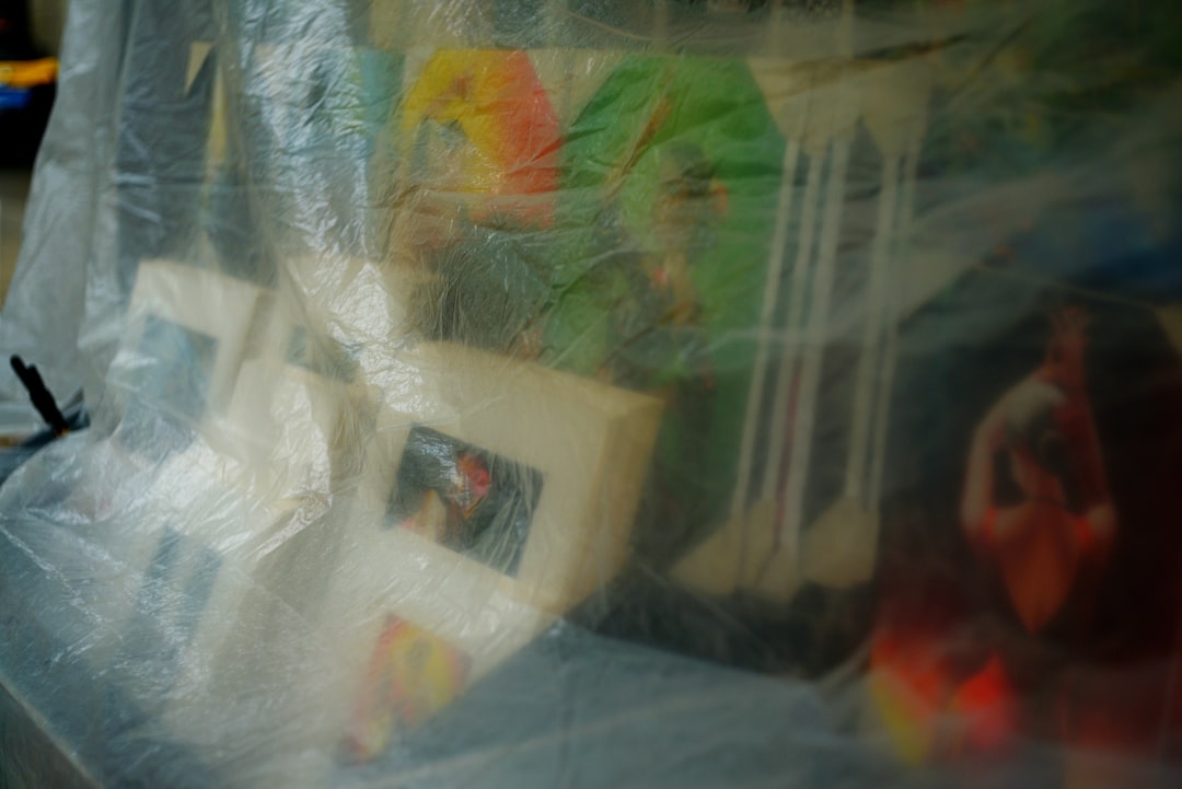 Several framed pictures covered in plastic wrap