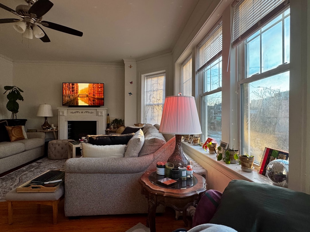 f910de7d7d0e4c16b2d8cc5e57770f2d Cozy living room with fireplace and large windows.