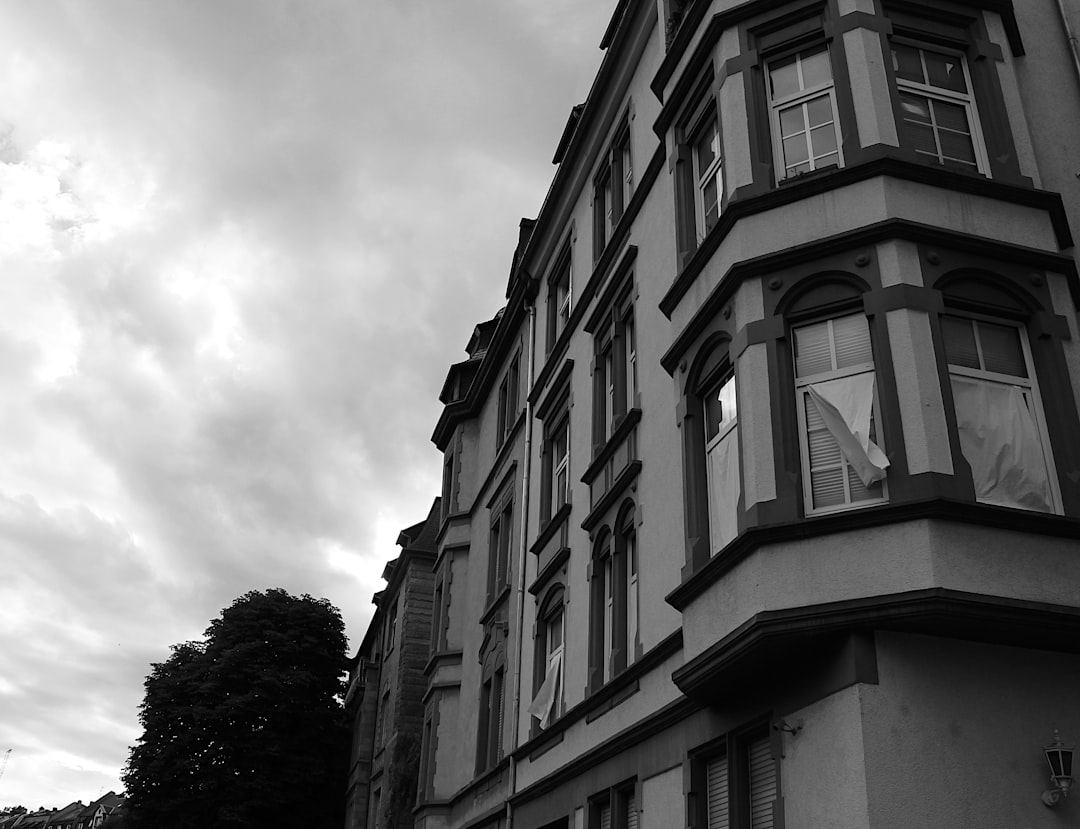Old building facade with bay windows under a cloudy sky