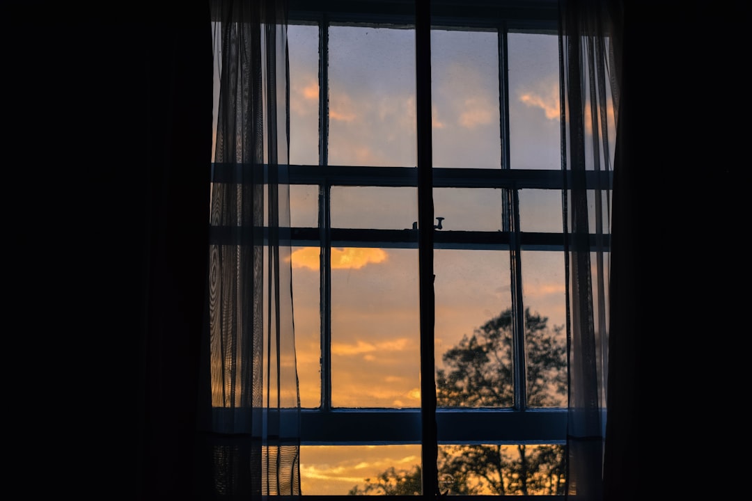 febd250659ef4410bd0e2e055f2e8299 photo of blue framed glass window with curtain