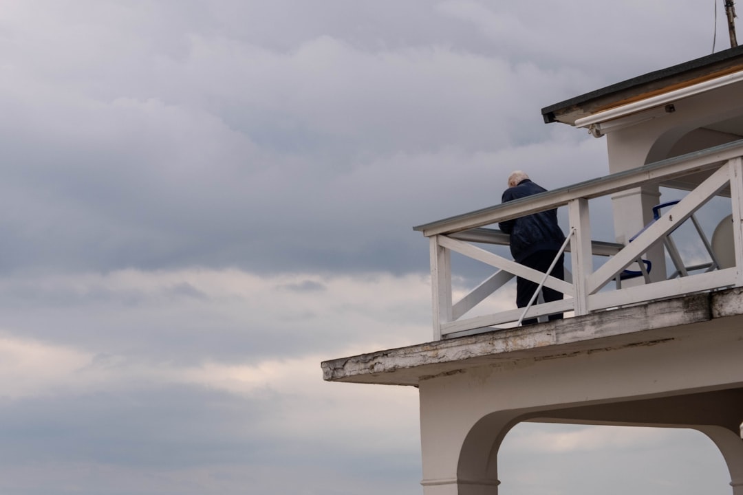 a man standing on a balcony of a building