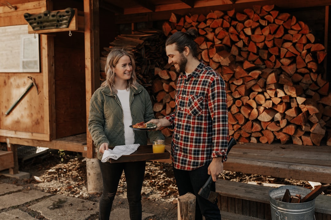 09821653fbf342f69d744b2d815c8f52 man and woman standing beside brown wooden table
