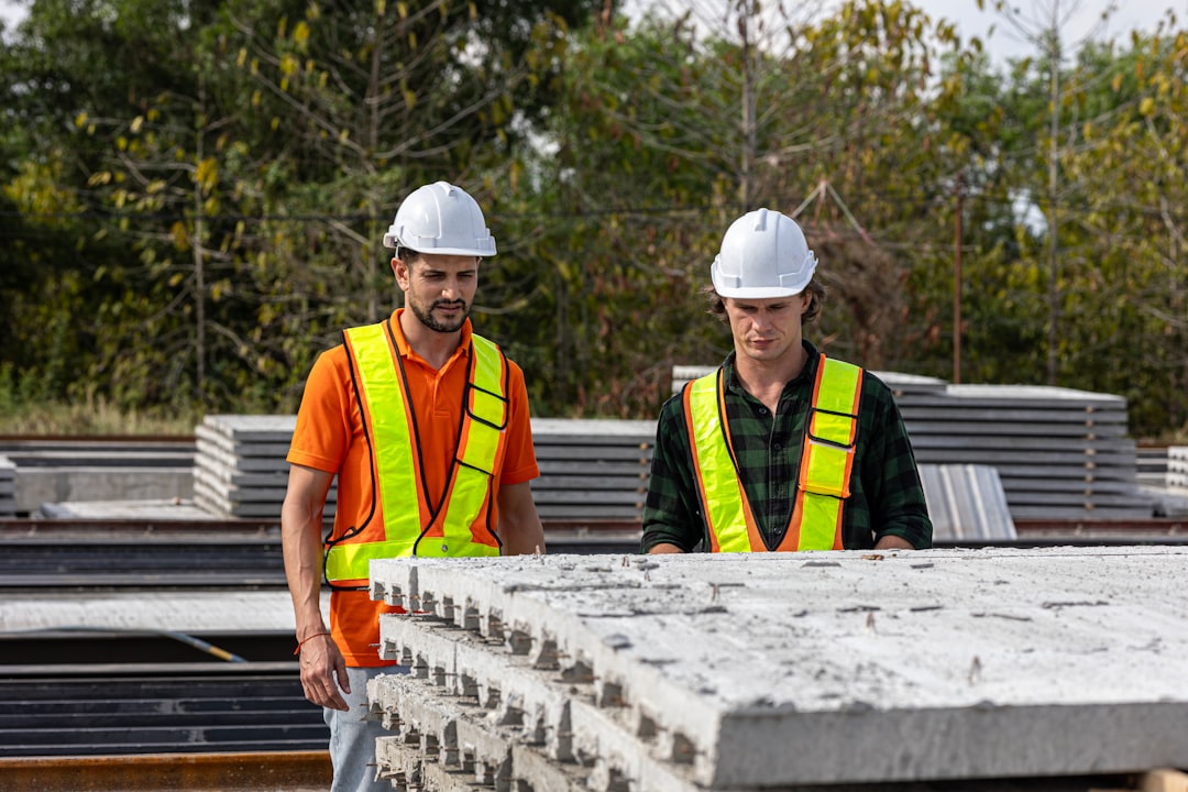 0e9e11b13d1d46509658e5b5636d1fdf Construction workers inspect concrete slabs