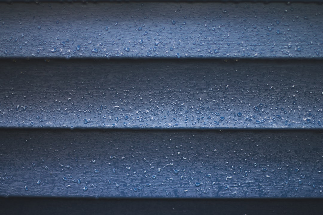 149043b152d746ffa5bf13bc4d4d7574 a close up of a blue wall with water droplets