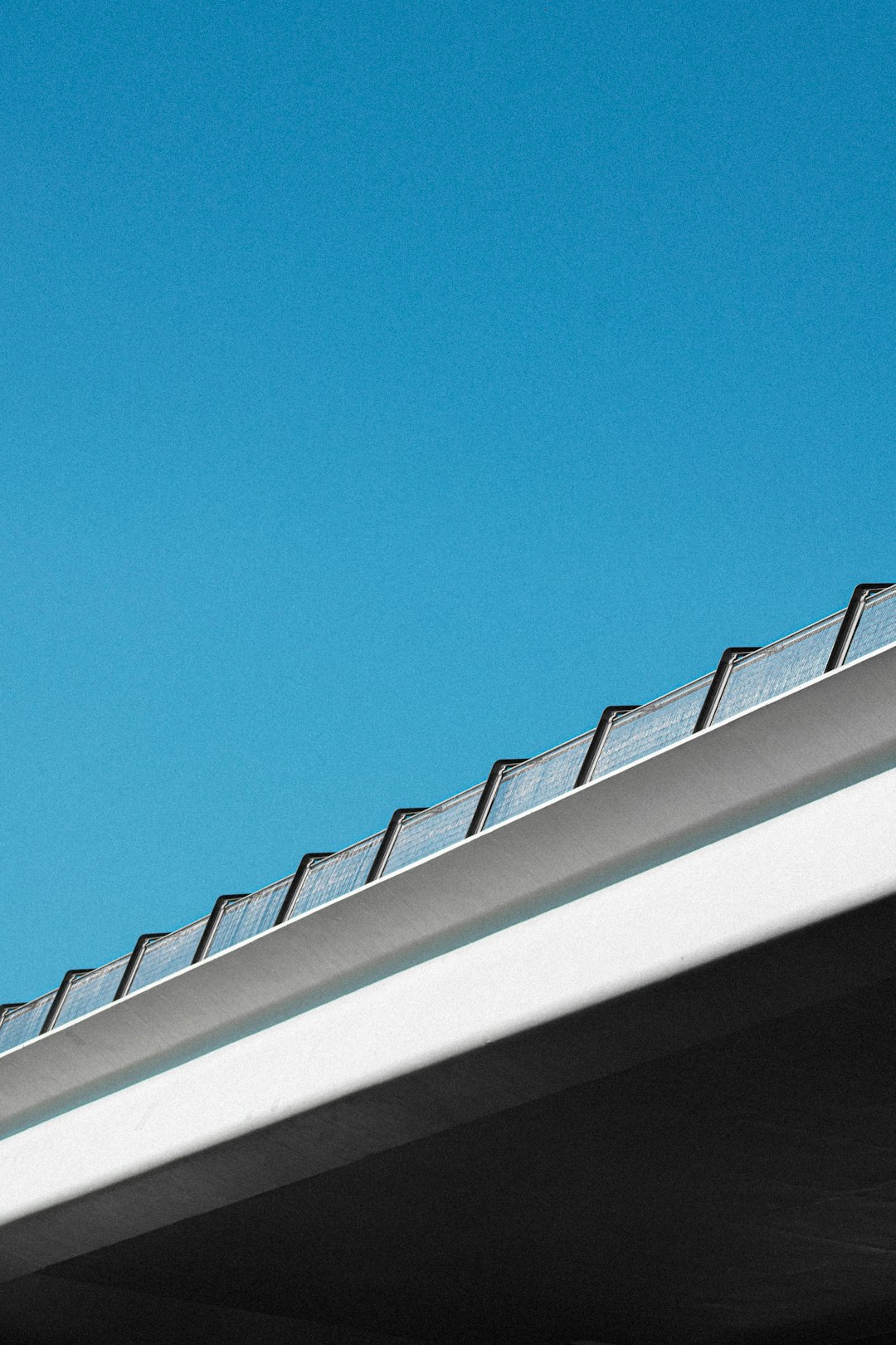 18e0b6e9211a4e99b0e0602e2a003c5c a bird is perched on the roof of a building