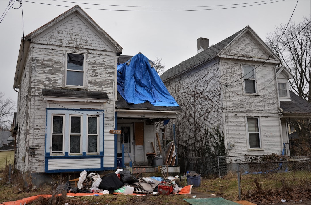 a house with a blue tarp on top of it