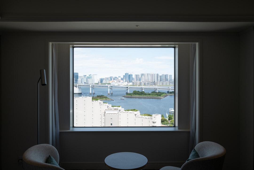 Cityscape view through a large window with chairs