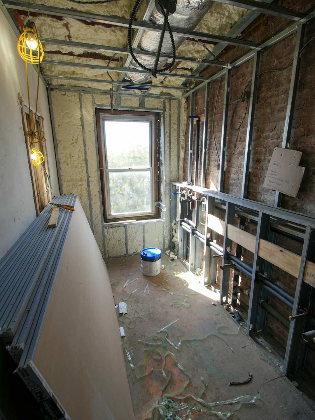 2c01b37356fd412794850fd6a746ba0d Room under construction with metal studs and drywall