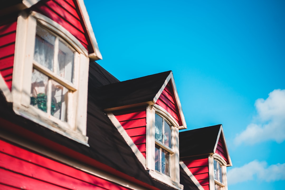 red and white wooden house under blue sky during daytime
