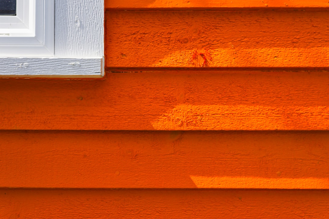 313f65c8fb284716860b1c24bf3528cd a close up of the side of an orange house