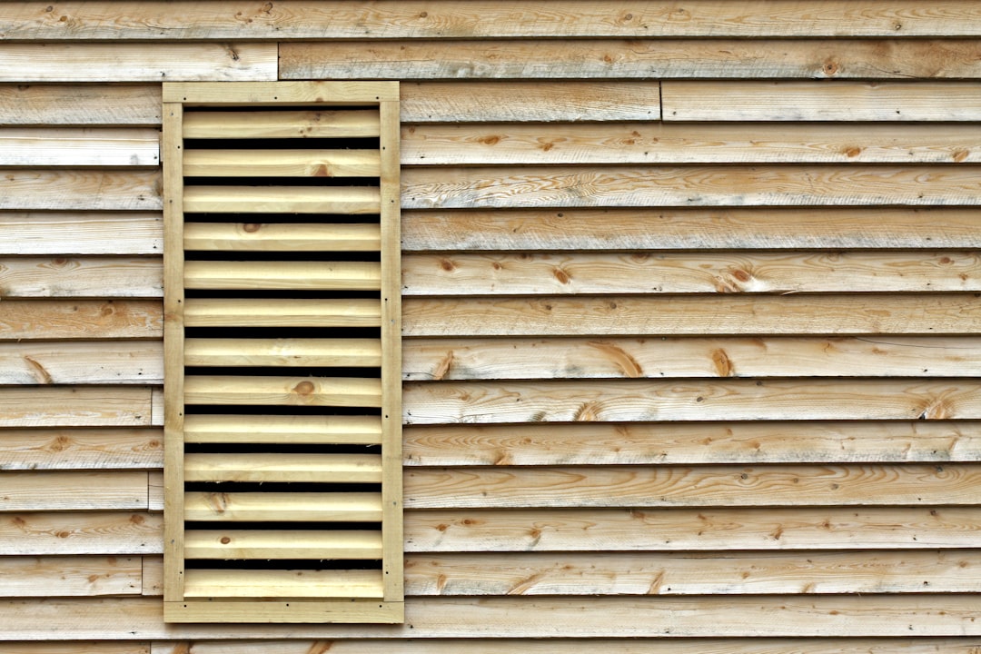 Wooden wall with a louvered vent