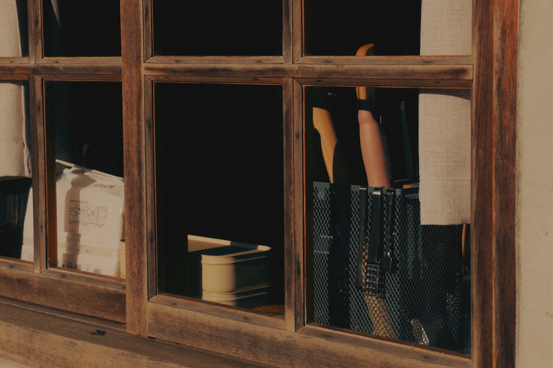 A person reaching for books through a window