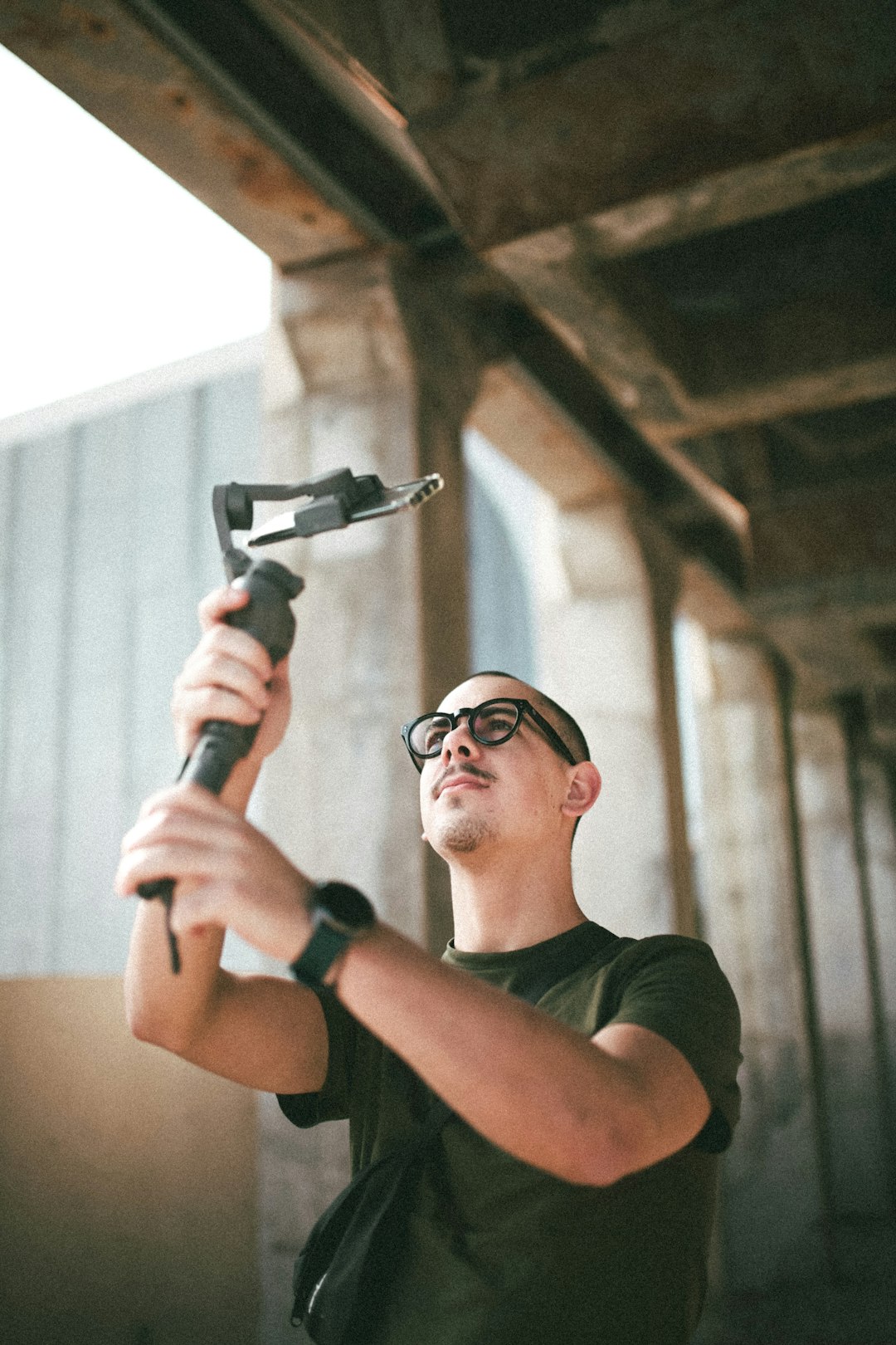 53f4e9f404024fadbf99cac391bb11f8 man in black crew neck t-shirt holding gray metal tool