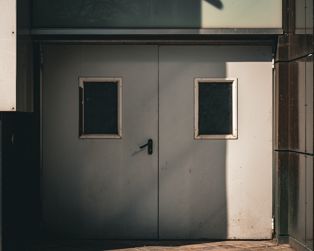 Double gray doors with two small windows
