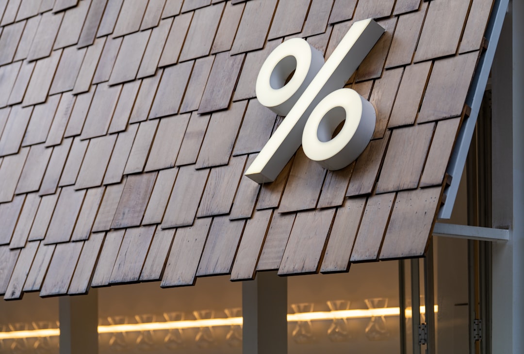 Large white percentage sign on wooden roof