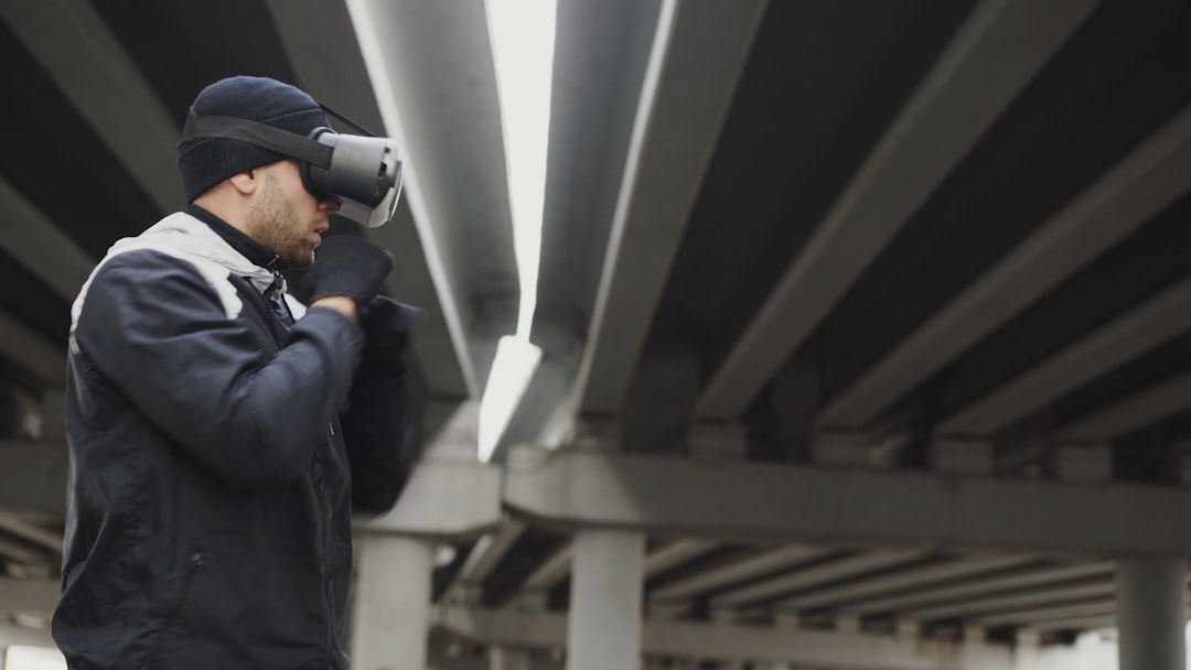 679705a838c9470490d8c921a3921d65 Man wearing vr headset under concrete bridge