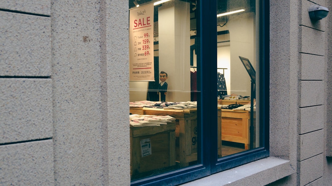 a man sitting at a desk in front of a window