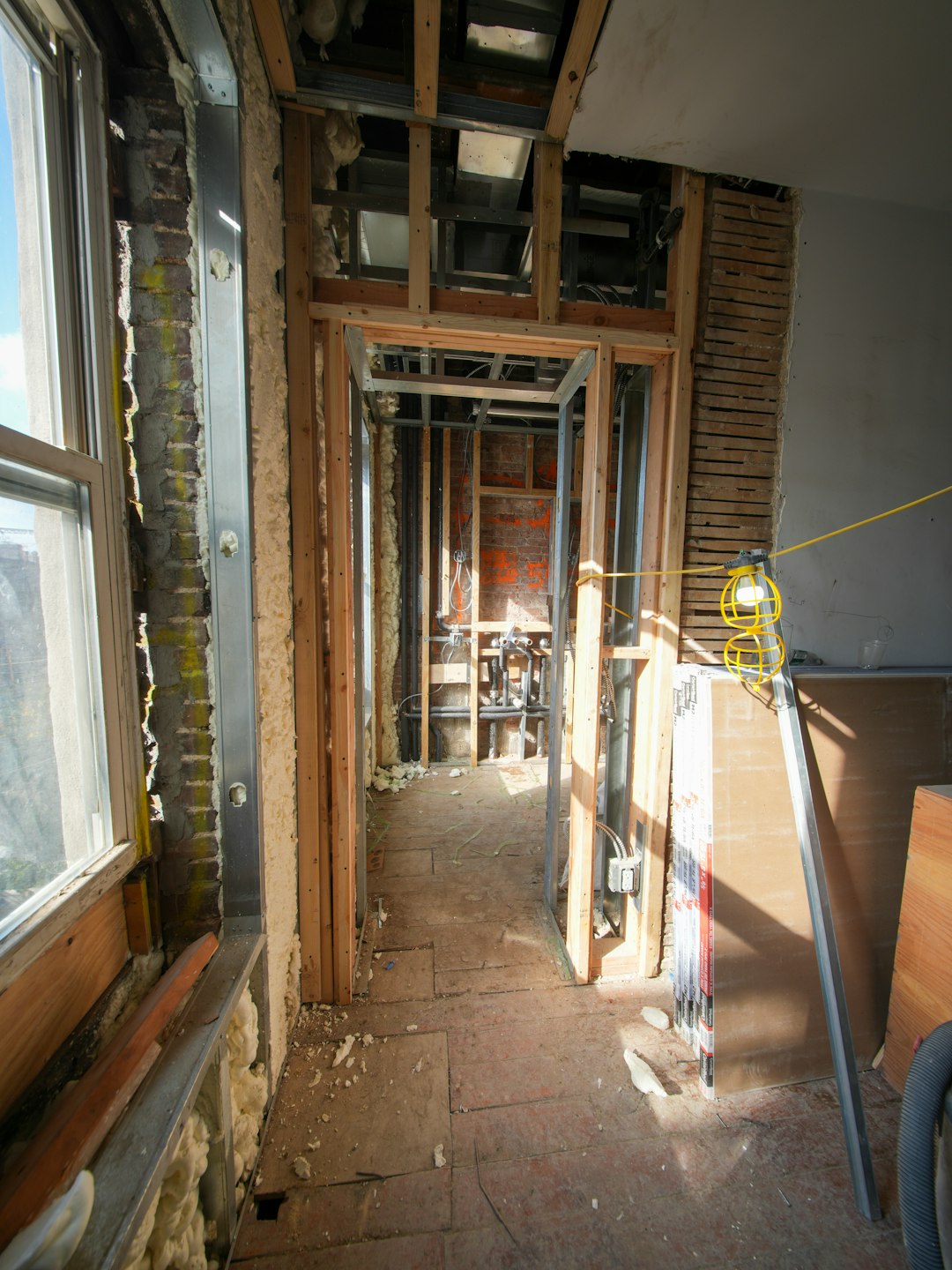 7386f60b111e45b2a5d32f3a36c4b771 Interior room under construction with exposed framing and unfinished walls