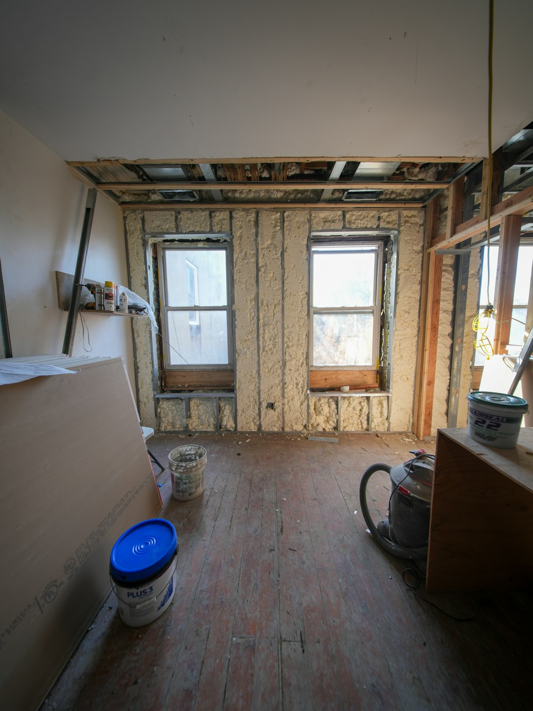 7ce7bf9a2e4348c6baa49b052e593f82 Room under construction with exposed walls and windows