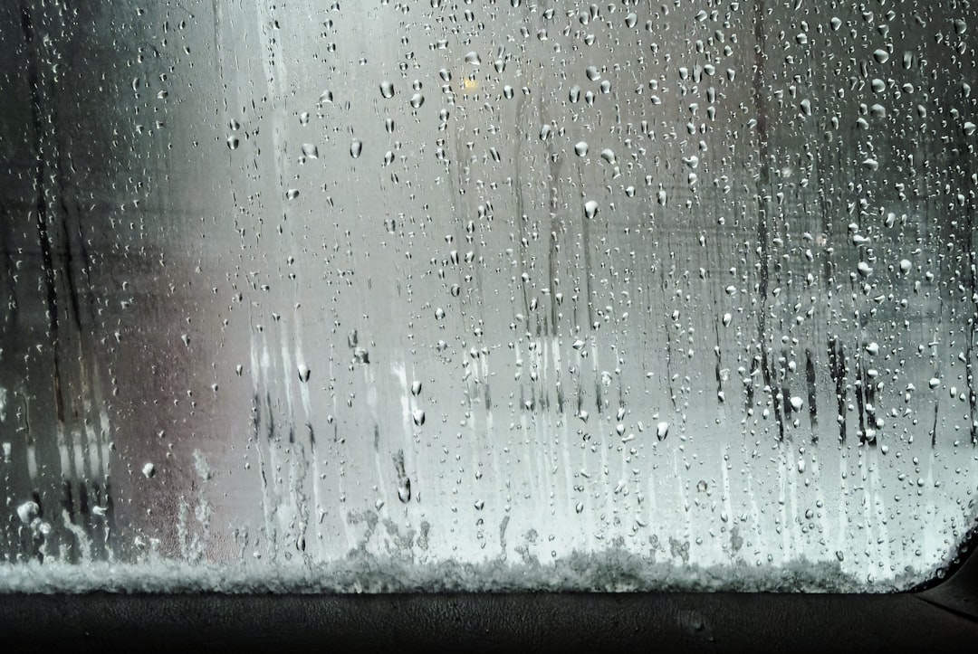 820a47cacdfb4707b2dead2e6207f8d9 a window with rain drops on it