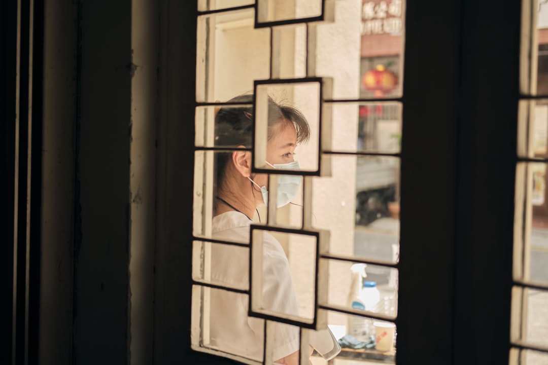 a man looking out of a window at the street