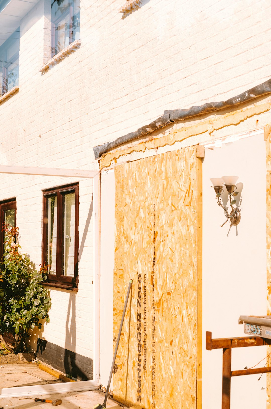 House renovation, white brick wall covered with osb