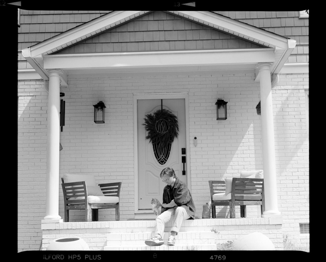 Young boy sitting on porch steps with dog