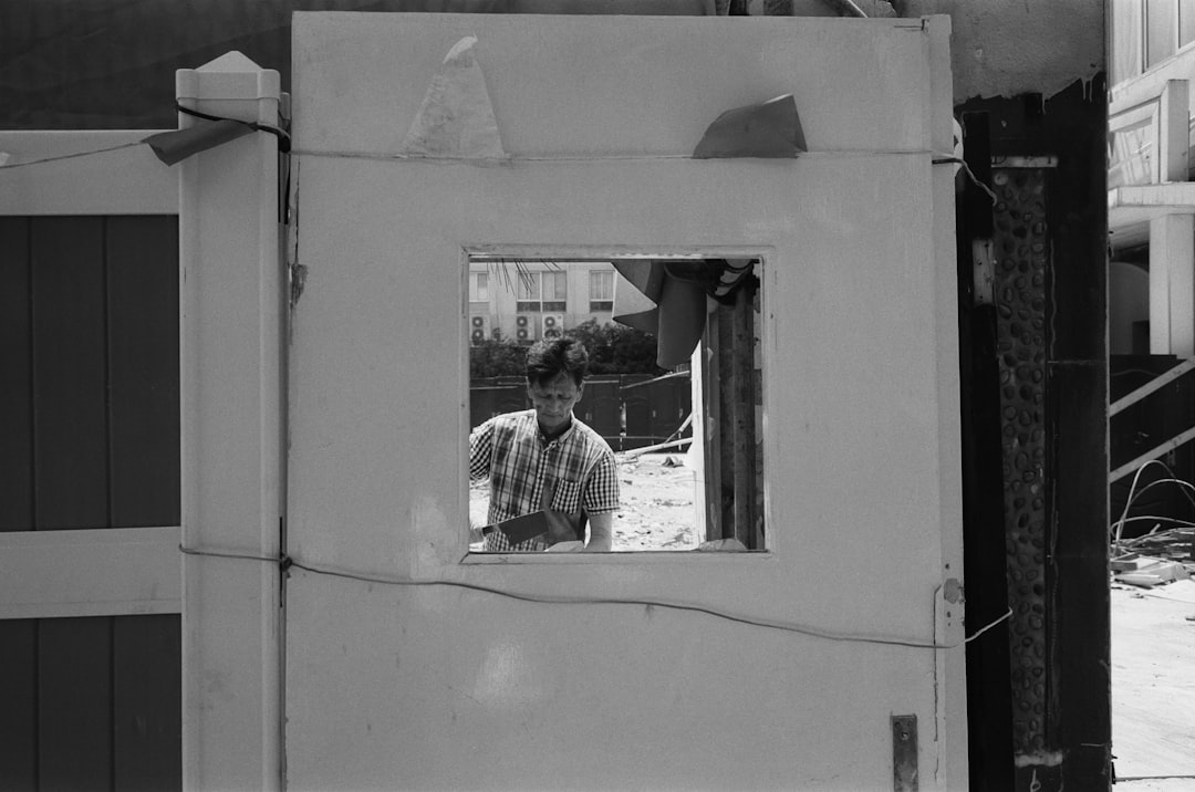 a man standing in a window of a building