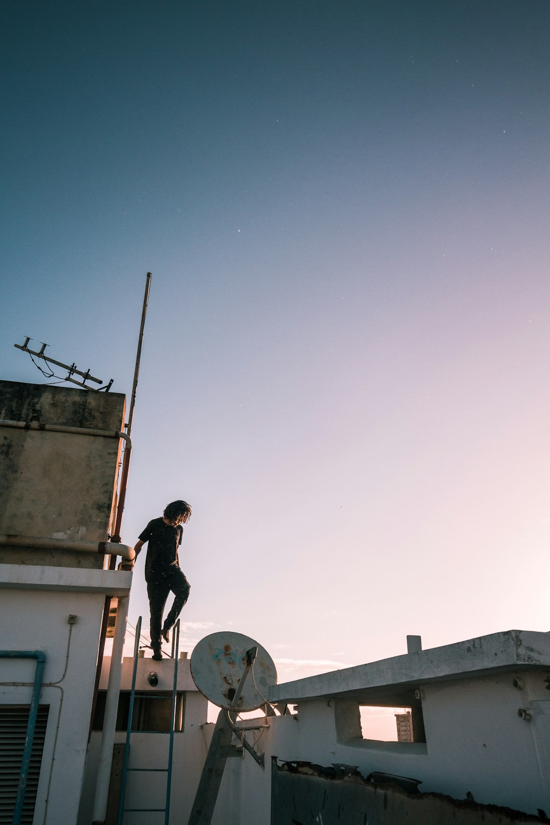 aacb937059c34124976f3c7aba483cfe man in black jacket and pants standing on white concrete building during daytime