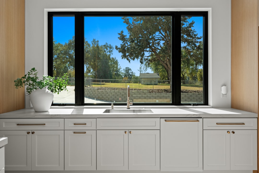 Kitchen sink and cabinets with a large window view
