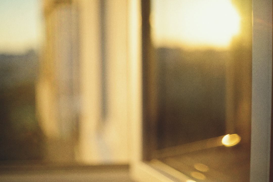 Golden sunset light streaming through an open window