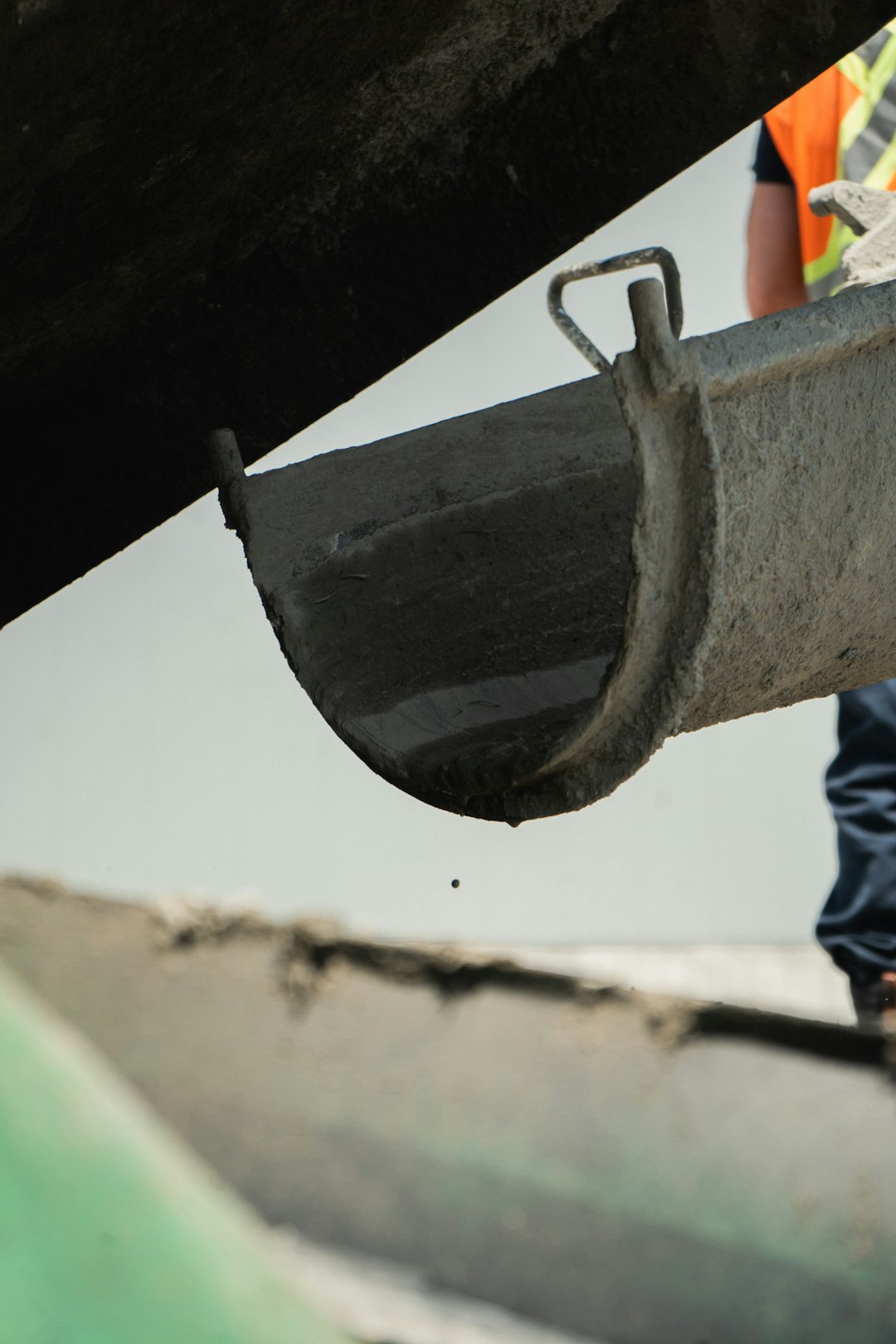 a man standing next to a metal pipe