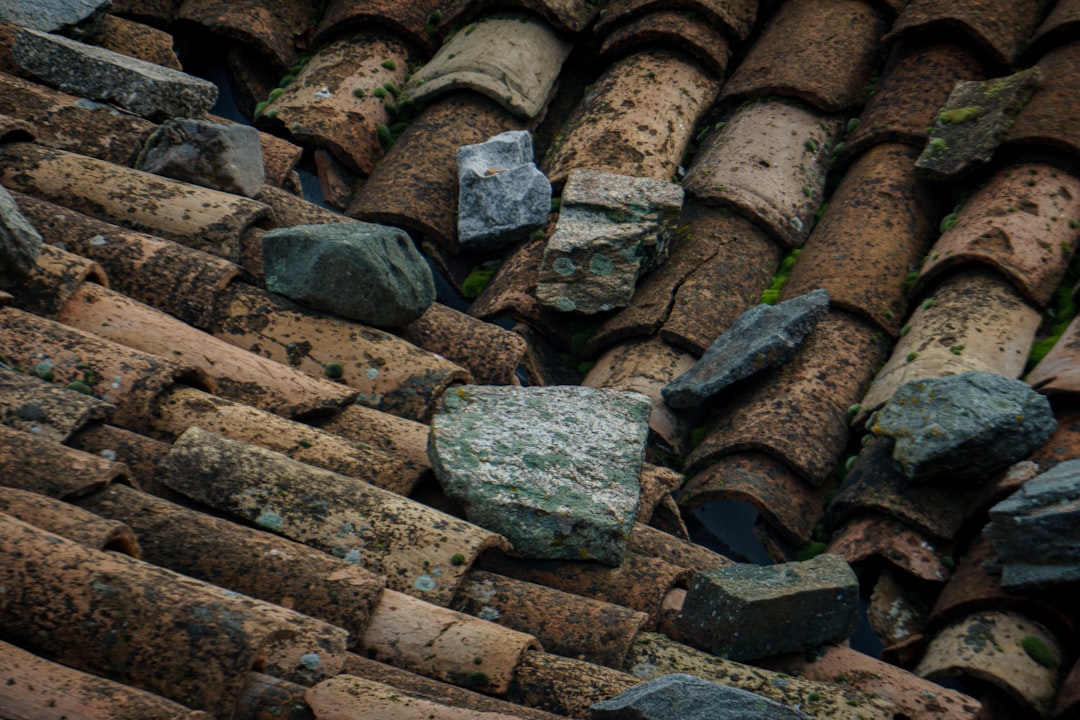 A close up of a roof with rocks on it