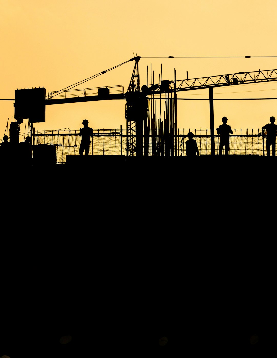 cd3ffdd531d444a4a6568070ee705605 silhouetted construction workers at sunset