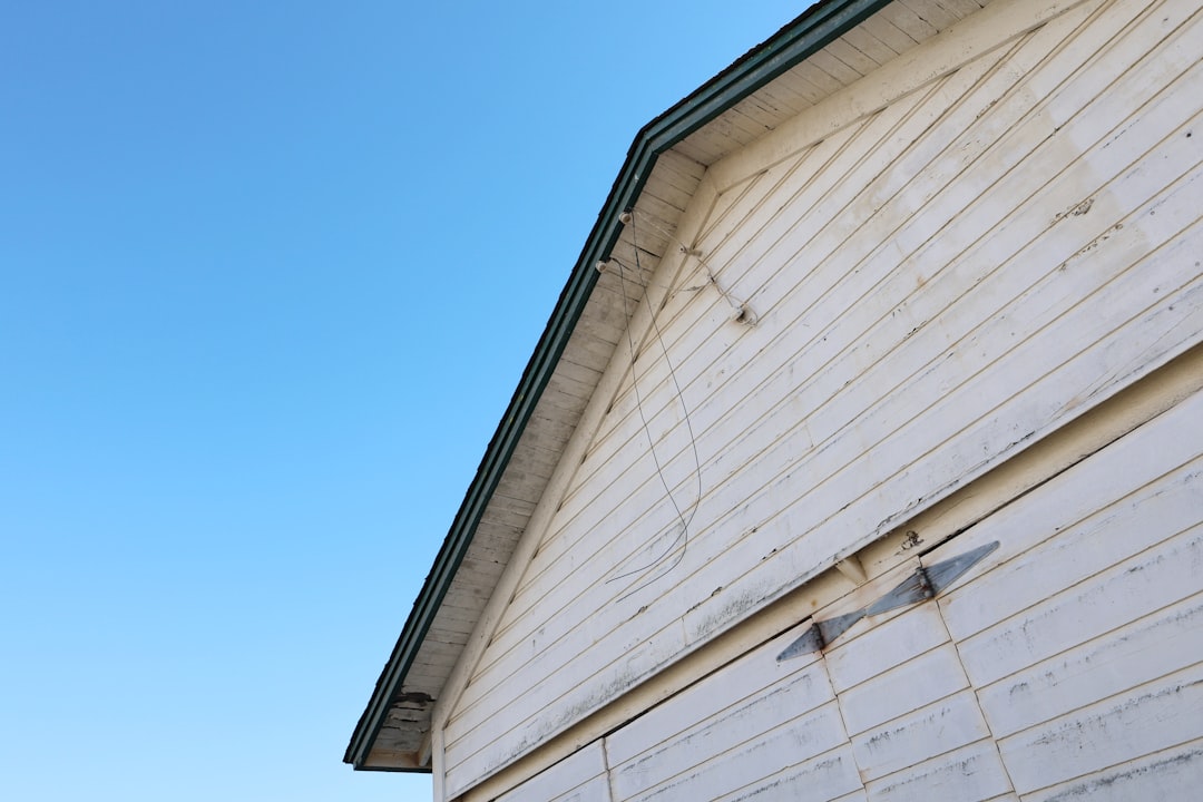Close-up of a white wooden wall against blue sky