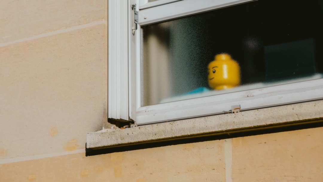 A lego head sits in a window